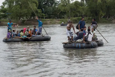 Encarni Pindado After waiting for more than 36 hours at the border bridge, some of the migrants crossed the border on rafts