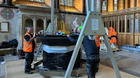 Luke Hughes Installing the glass top of the Trinity Church altar