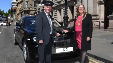 Glasgow City Council Former Lord Provost and driver standing beside Rolls Royce