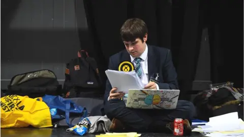 Getty Images SNP activist checks information