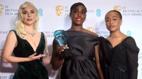 NEIL HALL Lashana Lynch (centre) with Lady Gaga (left) and last year's Rising Star winner Bukky Bakray