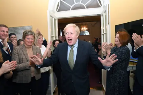 Stefan Rousseau / PA Boris Johnson is greeted by staff