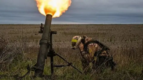 Getty Images A Ukrainian soldier fires a mortar