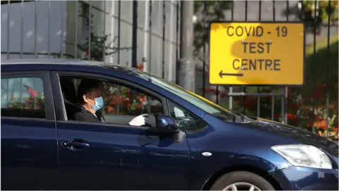 PA Media A car drives past a testing centre