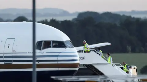 Reuters People boarding a plane