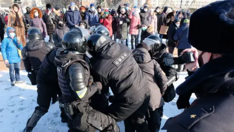 Getty Images Riot police officers detain a participant in an unauthorized rally in support of Russian opposition activist Alexei Navalny in Khabarovsk