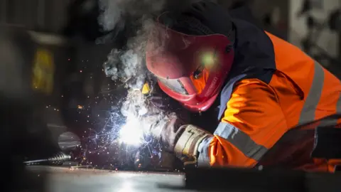 Steve Morgan/British Steel Steel worker cutting metal