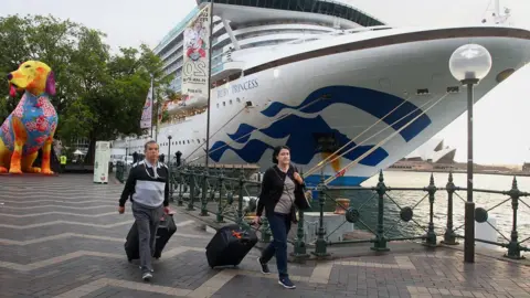 Getty Images Passengers disembarking from an earlier Ruby Princess voyage in February in Sydney