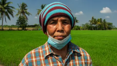 Bunchuay Somsuk in a rice field in Suphanburi, Thailand