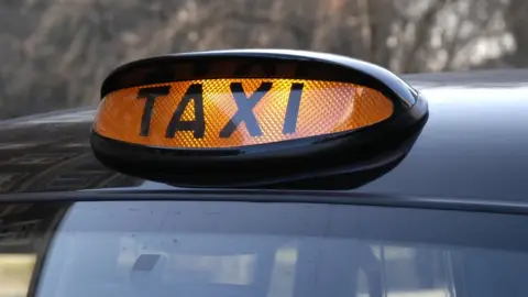 BBC A taxi light on showing a taxi is ready for hire