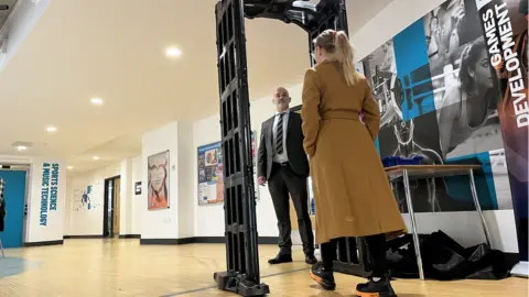 BBC A mobile knife arch being used