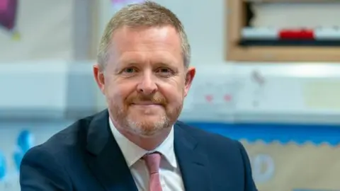 Welsh government Education Minister Jeremy Miles pictured in a primary school