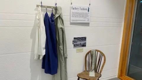 Rotherwas Together Overalls hung on a wall