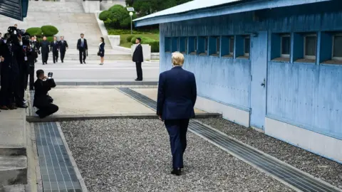 Getty Images Trump waits for the arrival of Kim