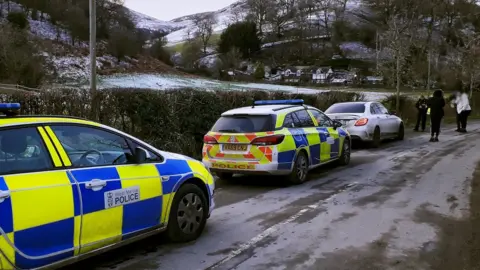 Police cars after the travellers were stopped