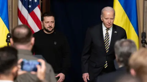 MICHAEL REYNOLDS/EPA-EFE/REX/Shutterstock US President Joe Biden (R) and Ukrainian President Volodymyr Zelensky (L) enter the room to hold a joint news conference in the Indian Treaty Room of the Eisenhower Executive Office Building, on the White House complex in Washington, DC, USA, 12 December 2023