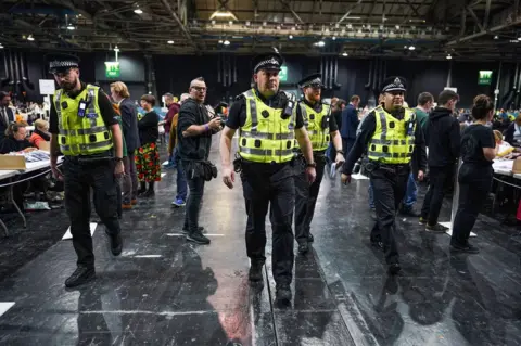 Getty Images Police take away ballot papers