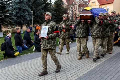 Reuters Photo of Ukrainian soldiers carrying the coffin of their fallen colleague, Sviatoslav Soyko, during his funeral in Uzhhorod, Ukraine. The young man died during the conflict with Russia.