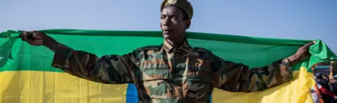 Getty Images Soldier holding a flag