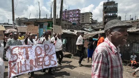 AFP Kenyan activists protest against extra-judicial killings by police officers in Mathare slum, a hotspot for summary 'executions' of suspected criminals allegedly by a police hit squad in Nairobi on April 13, 2022. -