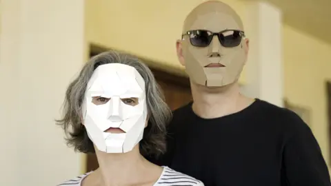 BBC Maria and Arthur, members of Team Ninja Trollhunters, stand next to each other wearing face masks to hide their identity