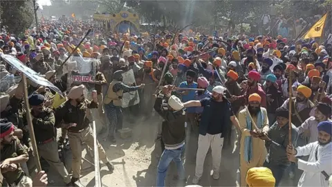 Getty Images Supporters of Waris Punjab De chief Amritpal Singh clashing with Punjab Police personnel on Thursday afternoon as they headed for the police station in Ajnala to protest the arrest of his aide in a kidnap and assault case on February 23, 2023