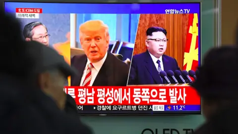 Getty Images Trump and Kim on a television in Seoul