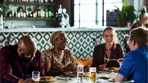 Getty Images picture of people socialising indoors