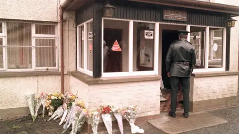Pacemaker A police officer at the Heights Bar in Loughinisland after the attack in 1994