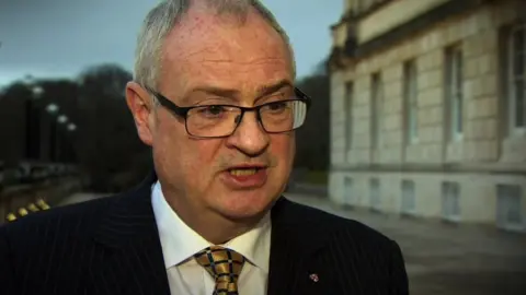 Steve Aiken talking outside Stormont