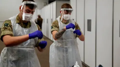 Reuters/Phil Noble Military personnel help with covid testing in Liverpool