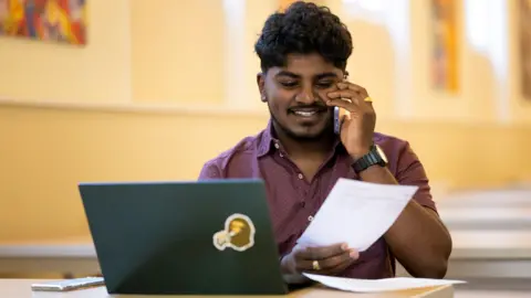 Getty Images A student on the phone