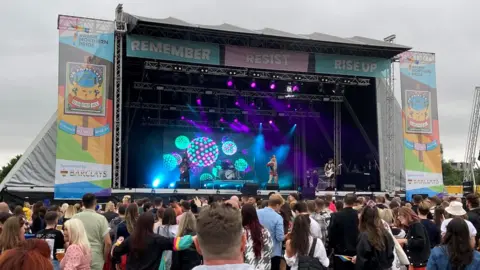 People watch a musical act on the stage