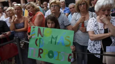 Getty Images "No more terrorism" sign held by a young girl