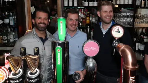 PA Donald Trump's sons, Donald Jr (left), and Eric Trump (right), got behind the bar in Doonbeg