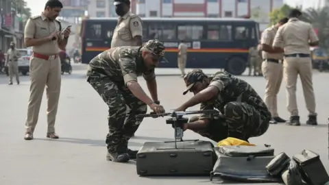 Getty Images A police surveillance team prepares to fly a drone in Shimoga, Karnataka on February 23, 2022, following violence that broke out