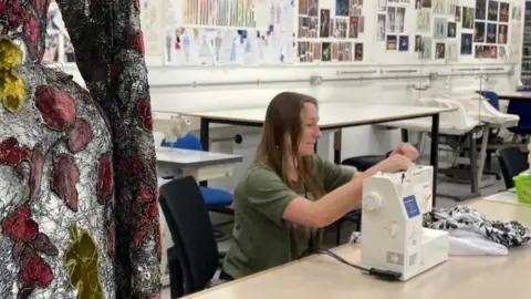 BBC Sophie Reed working with her sewing machine