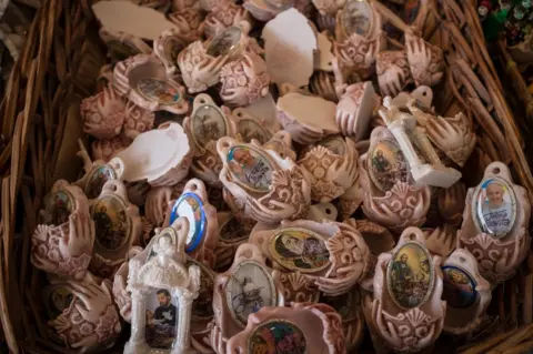 Erica Canepa A basket of holy water fonts