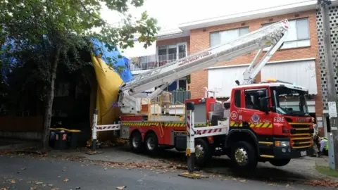 Police and rescue services work at the site of a hot air balloon accident in Elwood, Melbourne, Australia, 20 April 2022