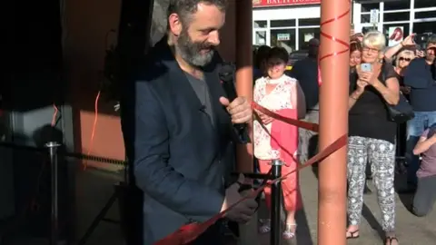 Actor Michael Sheen cutting the red ribbon