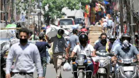 Getty Images A rush of people and motorists in a marketplace area as shops start opening in the city under specific guidelines, on May 20, 2020 in Jammu, India