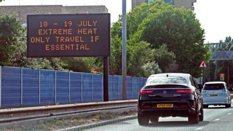 PA Media A weather travel warning for Monday and Tuesday is displayed on a road information panel on the A13 near Beckton in east London