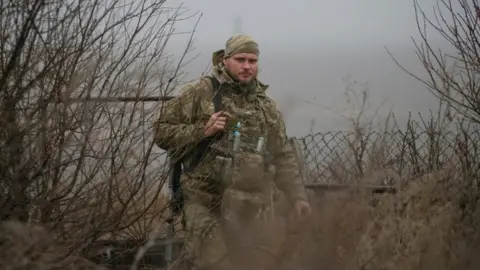 Reuters A Ukrainian serviceman is seen on the front line near the village of Travneve in Donetsk region, Ukraine, December 15, 2021