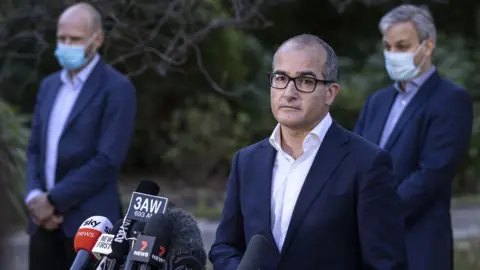 EPA James Merlino (middle) at a press conference in Melbourne