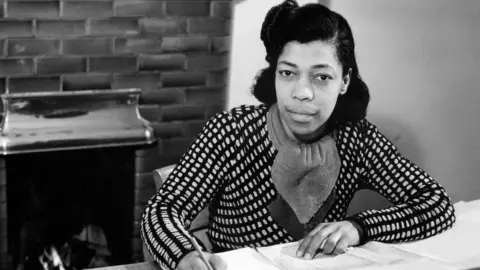 BBC Una Marson pictured at a writing desk in the BBC