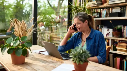 Getty Images Woman working on a laptop from a dining table