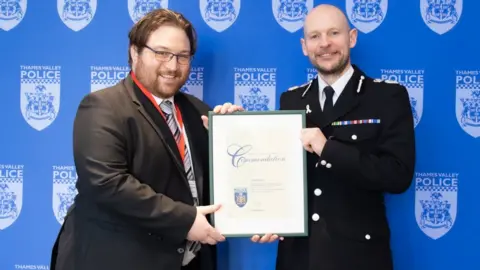 Thames Valley Police Chris Geraghty (left) is commended by Chief Constable Jason Hogg