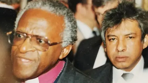 Mick Antoniw Desmond Tutu (L) and Hanef Bhamjee (R)