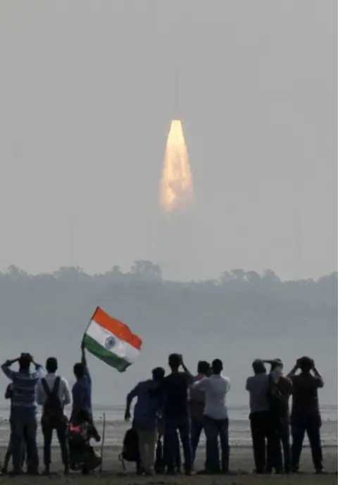 AFP Indian onlookers watch the launch of the Indian Space Research Organisation (ISRO) Polar Satellite Launch Vehicle (PSLV-C37) at Sriharikota on 15 February 2017.