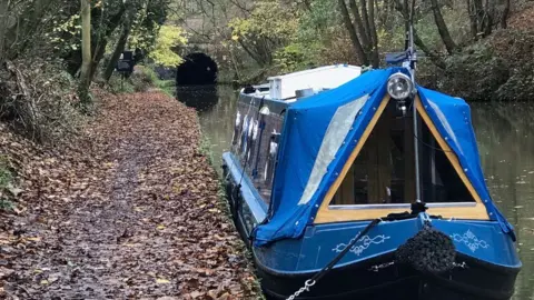 Rob Perryman Blue narrowboat in front of a tunnel